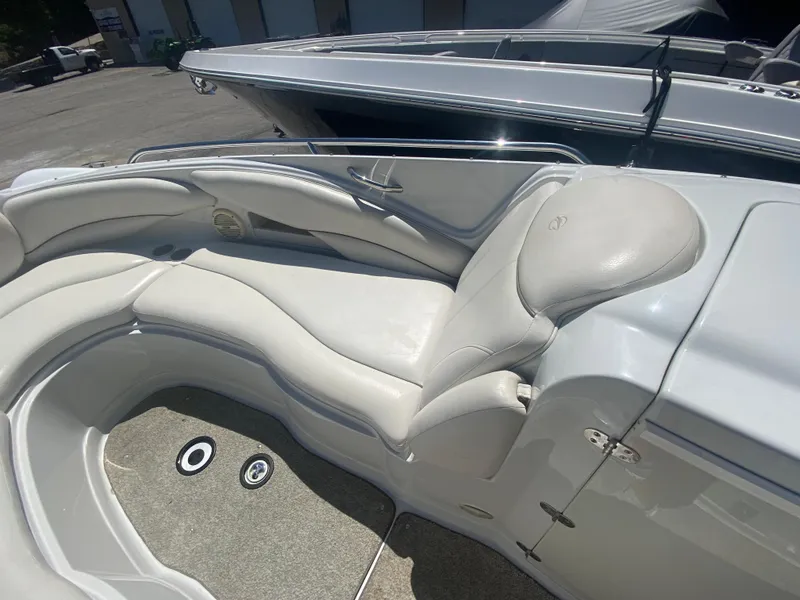 Slide: The Image of 2006 Crownline 320 LS boat interior with white leather seating and carpeted floor. - 31