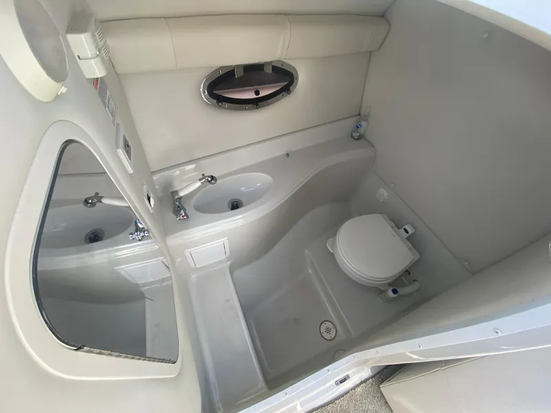 Slide: The Image of 2006 Crownline 320 LS boat bathroom with sink, toilet, and mirror. - 32