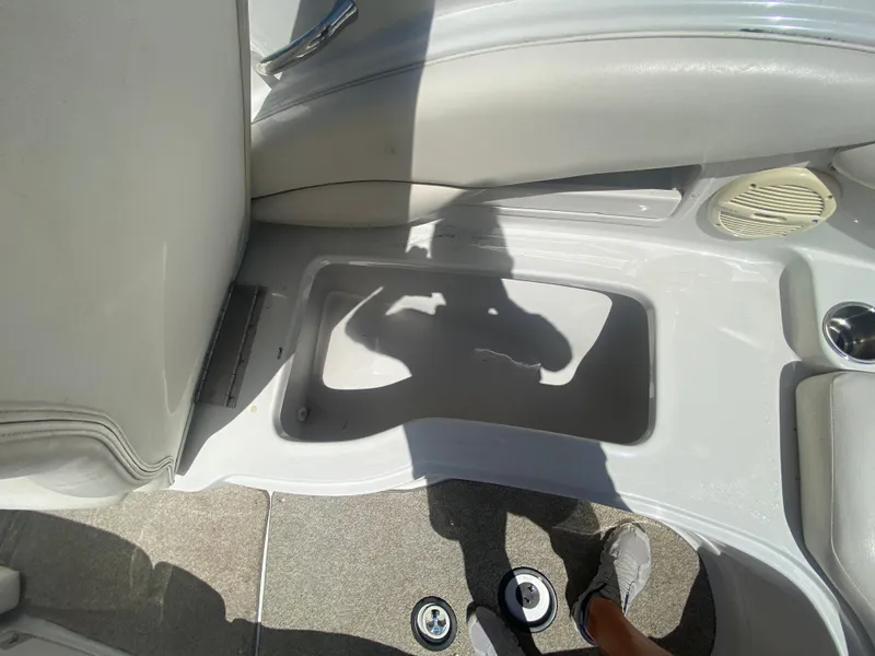 Slide: The Image of 2006 Crownline 320 LS boat interior with storage compartment and speaker. - 33
