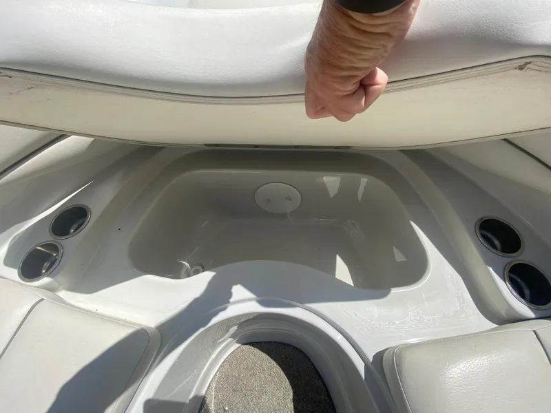 Slide: The Image of Storage compartment in a 2006 Crownline 320 LS boat, with cup holders and seating. - 35