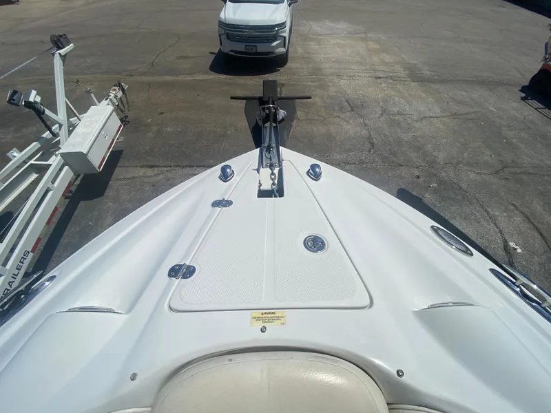 Slide: The Image of Bow view of 2006 Crownline 320 LS boat with trailer and vehicle in background. - 36