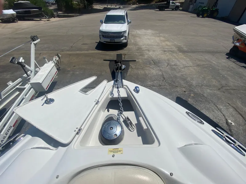 Slide: The Image of 2006 Crownline 320 LS boat bow with anchor chain, parked in a lot. - 37