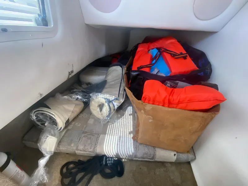Slide: The Image of Storage area in a 2006 Crownline 320 LS boat with life jackets and equipment. - 41