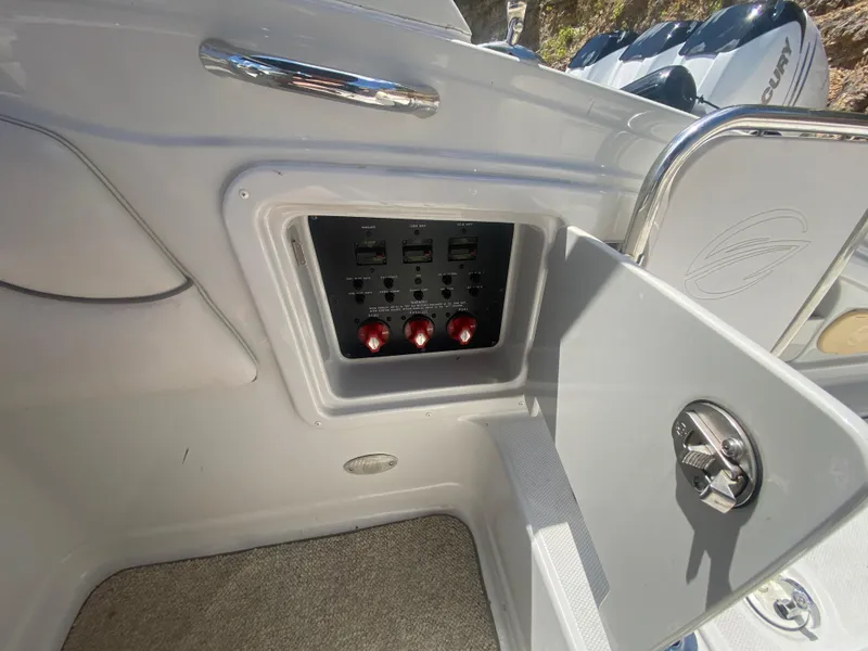 Slide: The Image of Control panel on a 2006 Crownline 320 LS boat, featuring switches and knobs. - 42