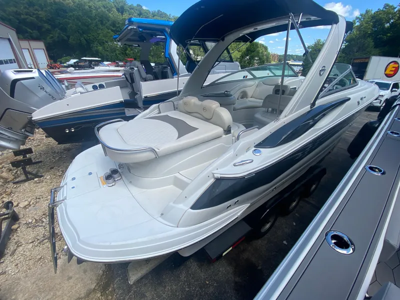 Slide: The Image of 2006 Crownline 320 LS boat with sleek design and spacious seating, docked outdoors. - 46
