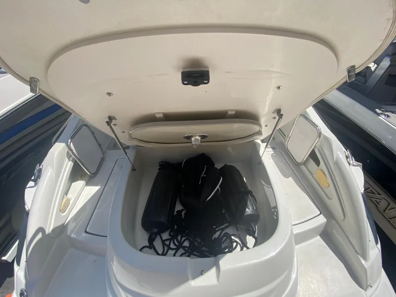 Slide: The Image of Open storage compartment on 2006 Crownline 320 LS boat with ropes and fenders inside. - 49