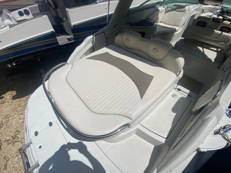 Slide: The Image of 2006 Crownline 320 LS boat interior with white seating and sleek design. - 9
