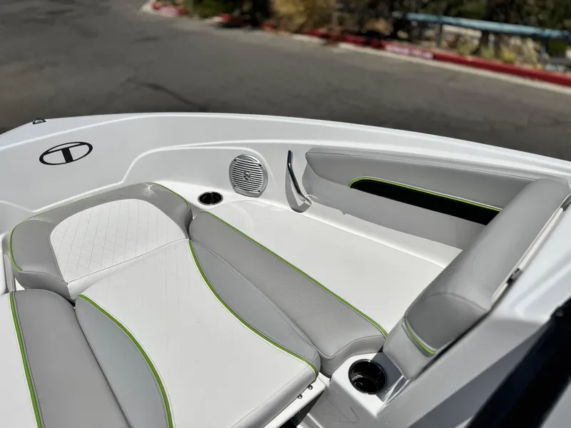 Slide: The Image of 2023 Tahoe 210 Si boat interior with gray and white seating, green accents. - 12