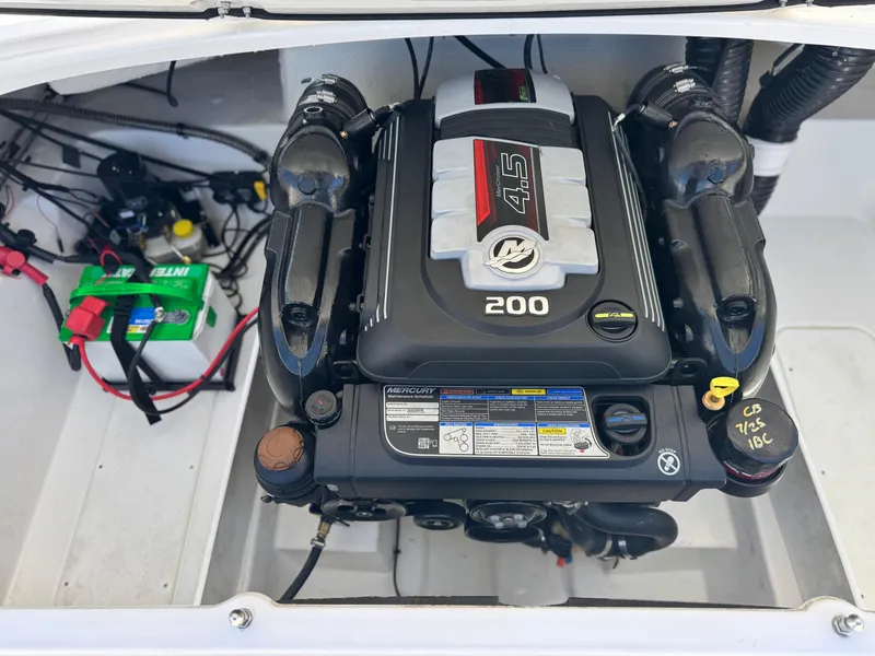 Slide: The Image of 2023 Tahoe 210 Si boat engine compartment with Mercury 4.5L 200 HP engine. - 17