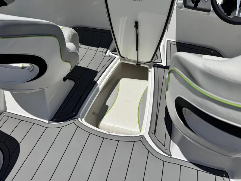 Slide: The Image of 2023 Tahoe 210 Si boat interior with open storage compartment and seating. - 18