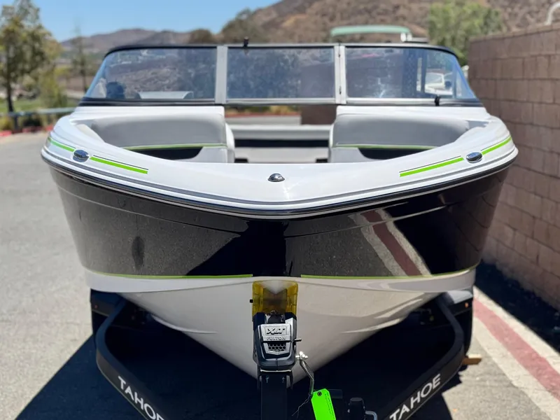 Slide: The Image of 2023 Tahoe 210 Si boat on trailer, front view, outdoors. - 2