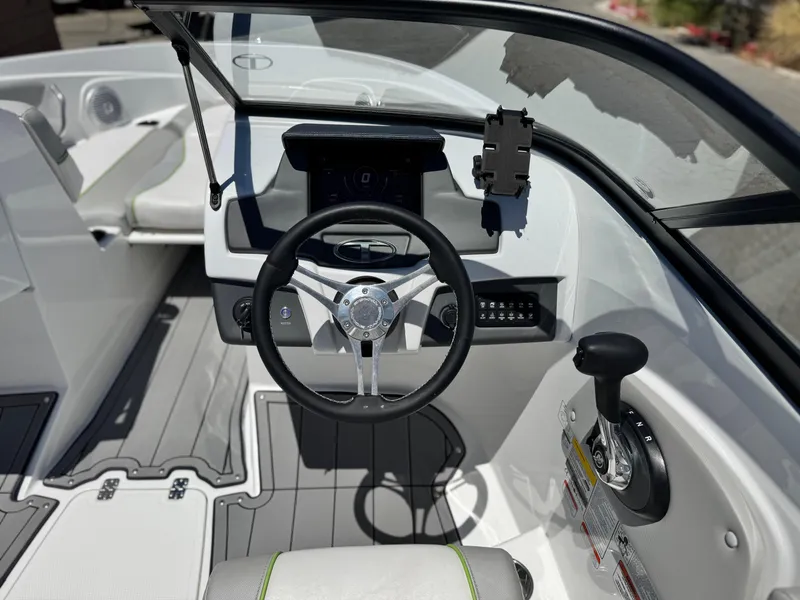 Slide: The Image of 2023 Tahoe 210 Si boat cockpit with steering wheel and control panel. - 22