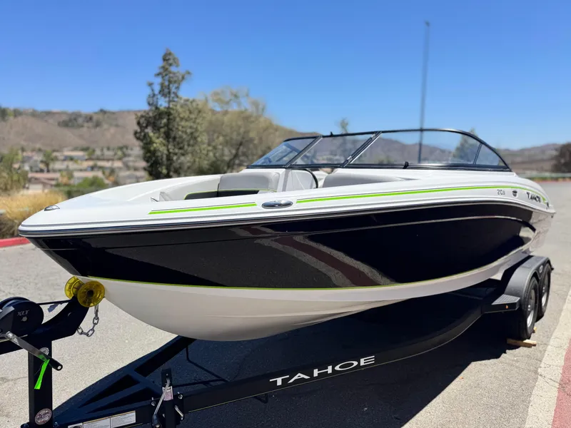 Slide: The Image of 2023 Tahoe 210 Si boat on trailer, sleek design, black and white exterior. - 3