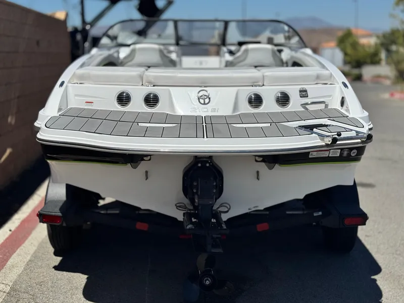 Slide: The Image of 2023 Tahoe 210 Si boat rear view, parked on a sunny day. - 4