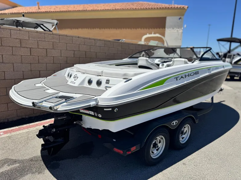 Slide: The Image of 2023 Tahoe 210 Si boat on trailer, sleek design, parked outdoors. - 5