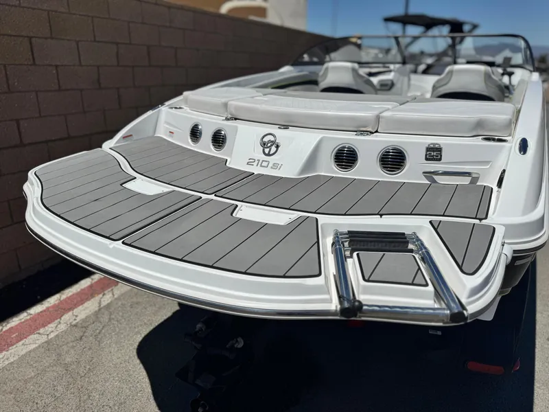 Slide: The Image of 2023 Tahoe 210 Si boat with sleek design and swim platform. - 6