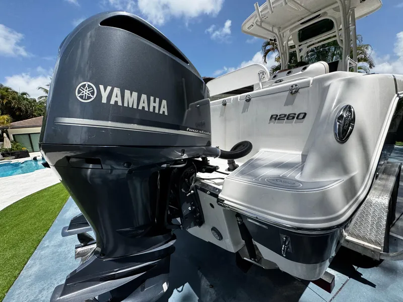 Slide: The Image of 2016 Robalo R260 Center Console with Yamaha engine, parked outdoors on a sunny day. - 10