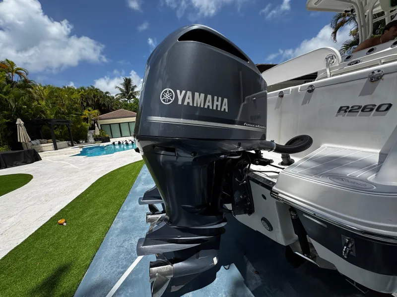 Slide: The Image of 2016 Robalo R260 Center Console with Yamaha outboard motor by a poolside. - 11