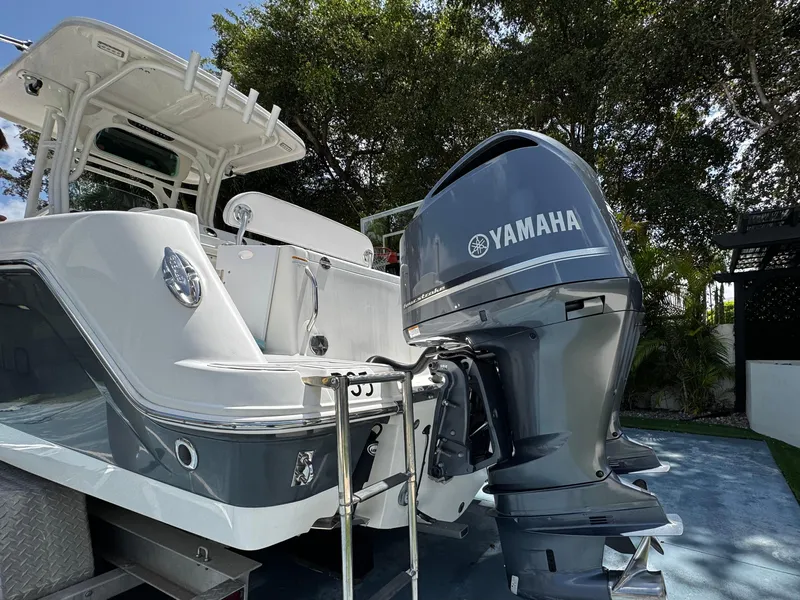 Slide: The Image of 2016 Robalo R260 Center Console boat with Yamaha outboard motor, parked outdoors. - 12