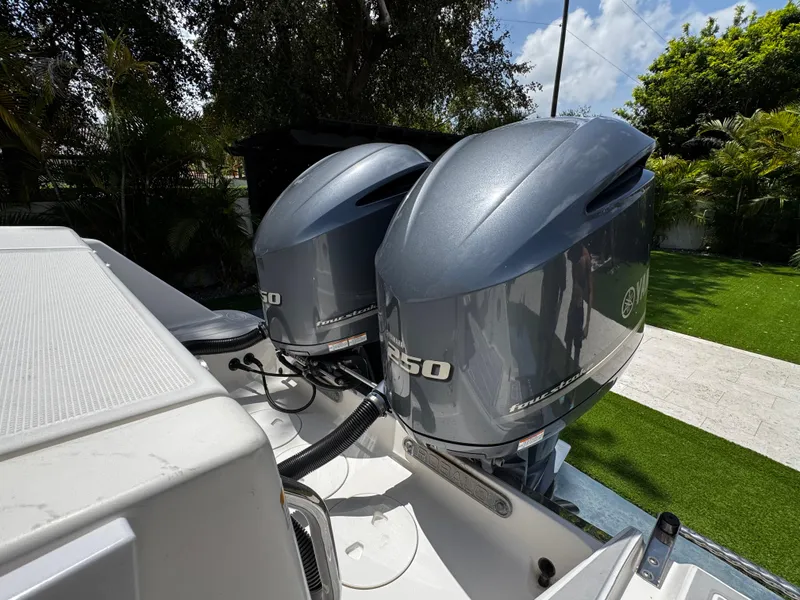 Slide: The Image of 2016 Robalo R260 Center Console with dual Yamaha outboard motors in a sunny outdoor setting. - 13