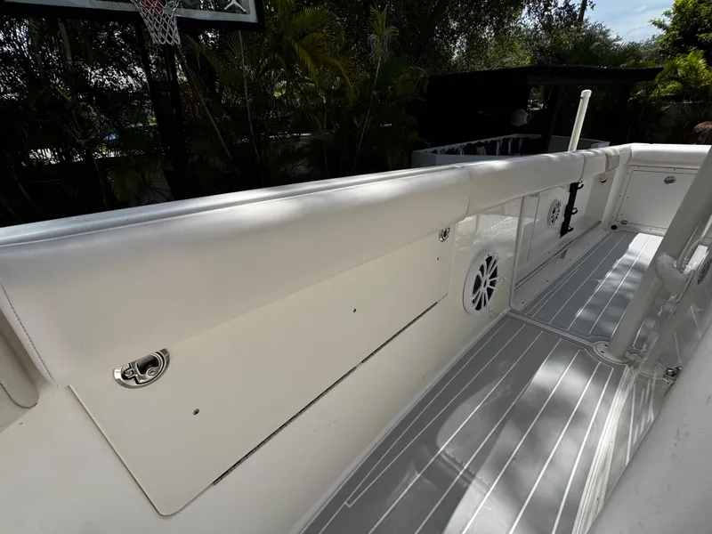 Slide: The Image of 2016 Robalo R260 Center Console boat interior with white seating and speaker. - 18