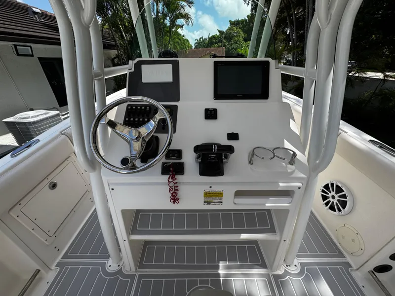 Slide: The Image of 2016 Robalo R260 Center Console boat helm with steering wheel and controls. - 28