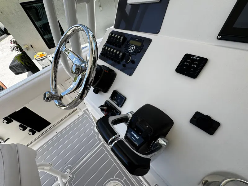 Slide: The Image of 2016 Robalo R260 Center Console helm with steering wheel and control panel. - 29