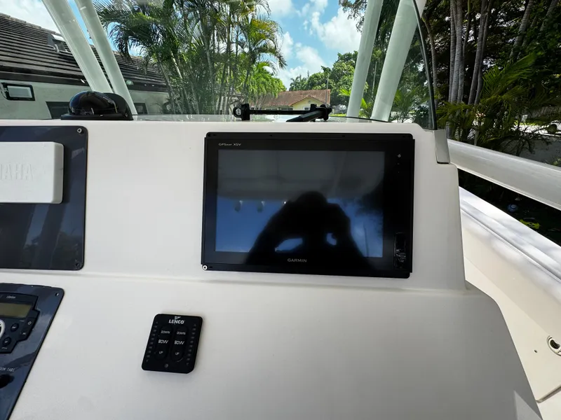 Slide: The Image of 2016 Robalo R260 Center Console dashboard with Garmin GPS and Lenco controls. - 30