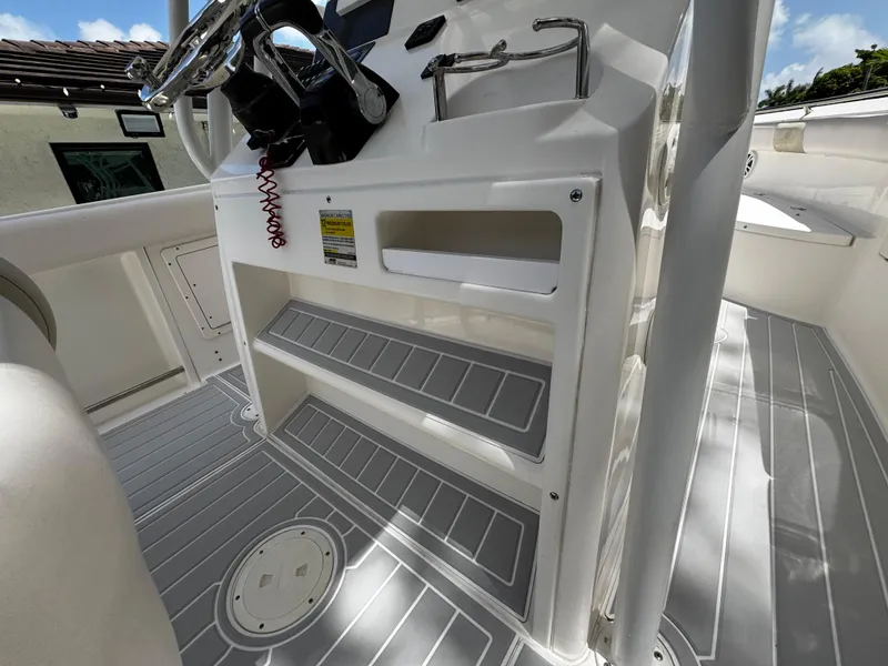 Slide: The Image of 2016 Robalo R260 Center Console interior with steering wheel and storage compartments. - 33