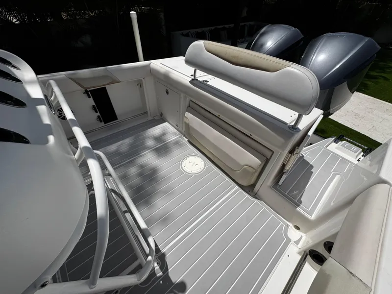Slide: The Image of 2016 Robalo R260 Center Console boat interior with seating and dual engines. - 35