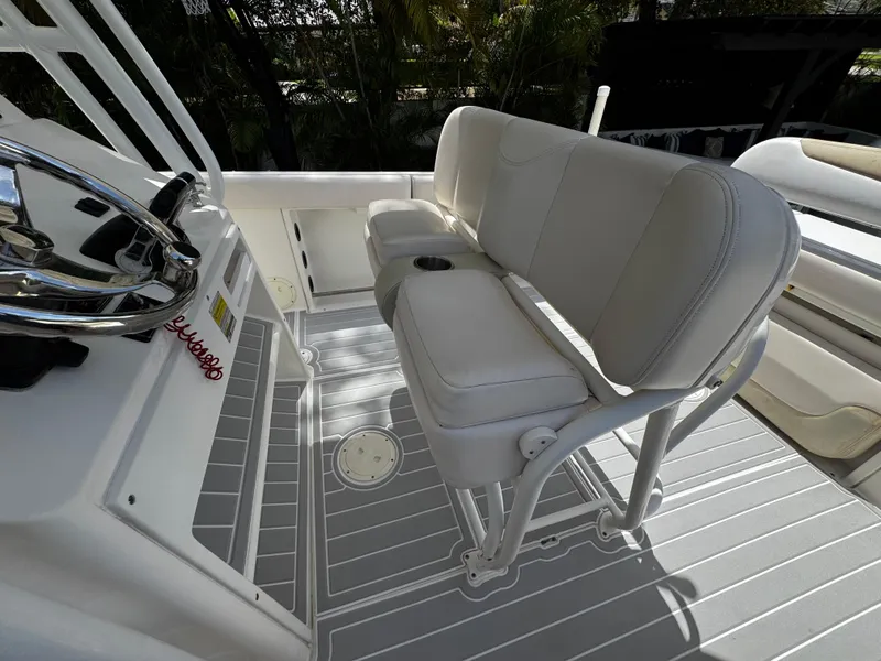 Slide: The Image of 2016 Robalo R260 Center Console boat interior with white seating and steering wheel. - 36
