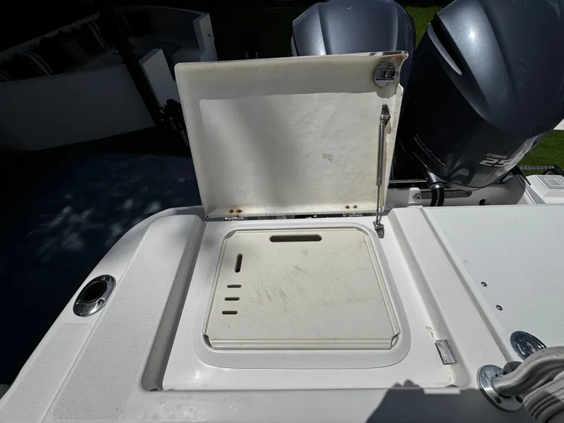 Slide: The Image of 2016 Robalo R260 Center Console boat with open storage compartment and dual Yamaha engines. - 39