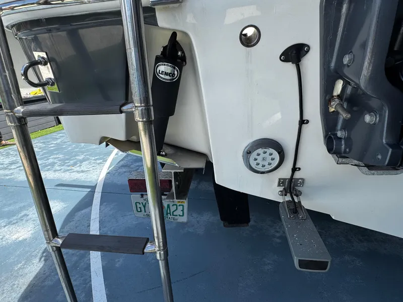 Slide: The Image of 2016 Robalo R260 Center Console boat stern with ladder and Lenco trim tab. - 41