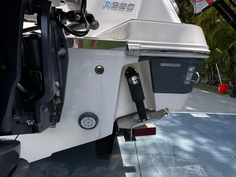 Slide: The Image of 2016 Robalo R260 Center Console boat stern with visible engine components. - 42