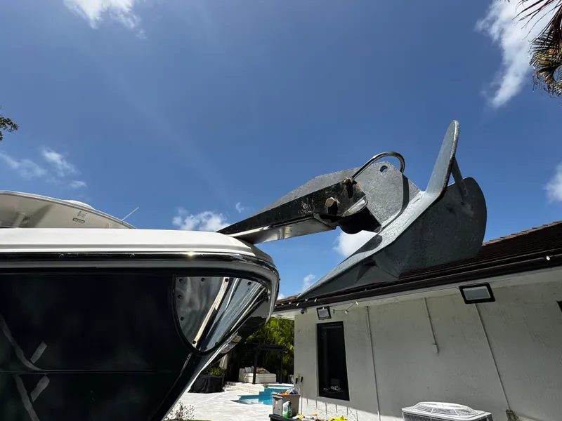 Slide: The Image of 2016 Robalo R260 Center Console boat with anchor, under clear blue sky. - 43
