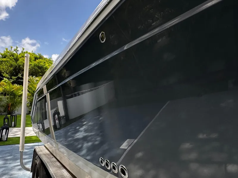 Slide: The Image of 2016 Robalo R260 Center Console boat on trailer, side view, outdoors. - 7