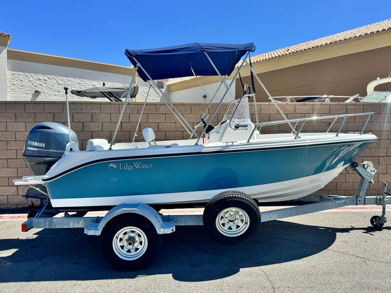 Slide: The Image of 2017 Edgewater 170CC boat on trailer with Yamaha outboard motor, parked outdoors. - 0