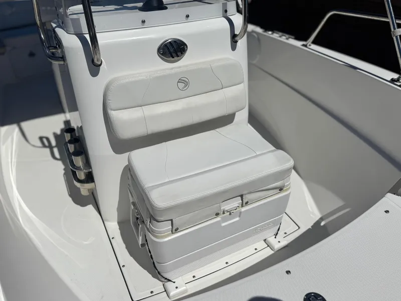 Slide: The Image of 2017 Edgewater 170CC boat interior with cushioned seating and storage compartment. - 10