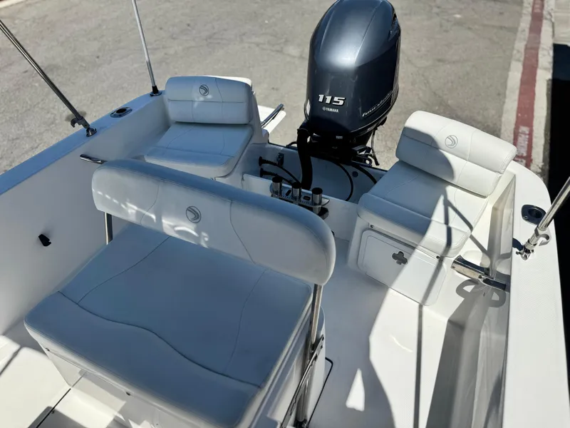 Slide: The Image of 2017 Edgewater 170CC boat interior with Yamaha 115 engine, featuring white seating and storage. - 13