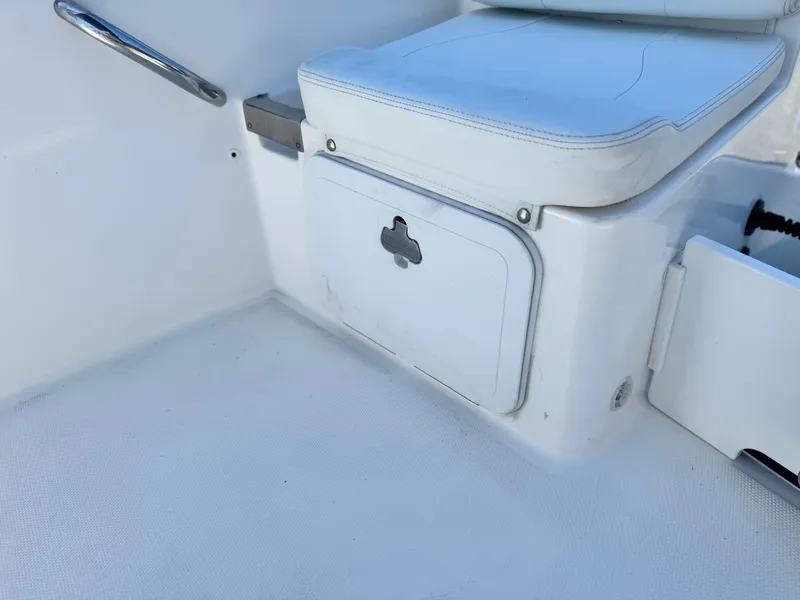 Slide: The Image of Edgewater 170CC 2017 boat interior with white seating and storage compartment. - 15