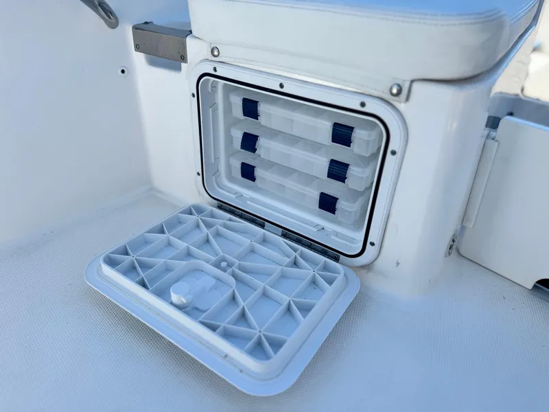 Slide: The Image of Open storage compartment on 2017 Edgewater 170CC boat with organized trays. - 16