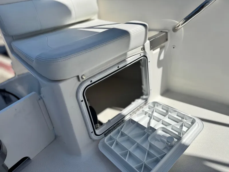 Slide: The Image of Open storage compartment on a 2017 Edgewater 170CC boat with cushioned seating. - 17