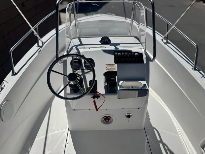 Slide: The Image of 2017 Edgewater 170CC boat console with steering wheel and controls. - 21