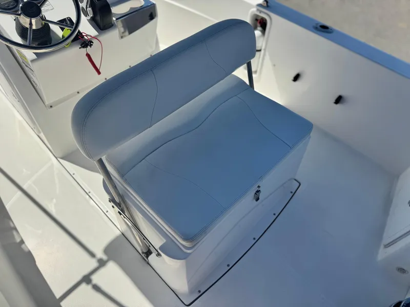 Slide: The Image of 2017 Edgewater 170CC boat interior with steering wheel and cushioned seat. - 24