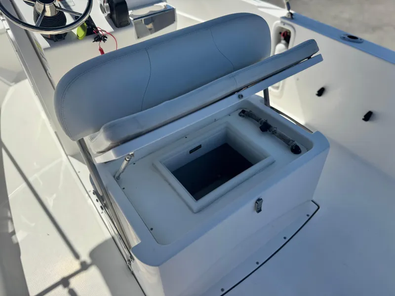 Slide: The Image of 2017 Edgewater 170CC boat interior with open storage compartment and steering console. - 25