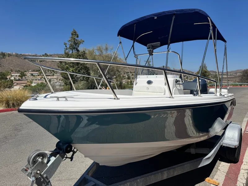 Slide: The Image of 2017 Edgewater 170CC boat on trailer with blue canopy, parked outdoors. - 3