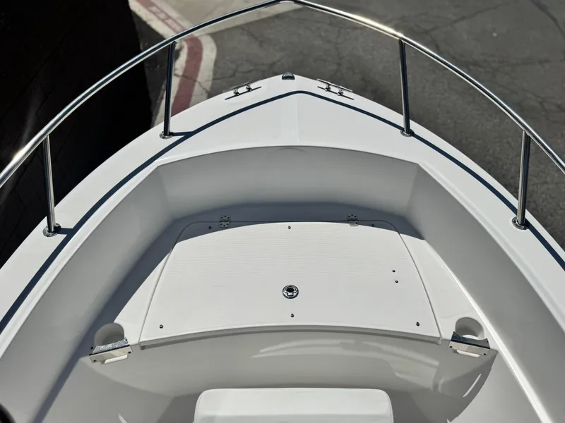 Slide: The Image of 2017 Edgewater 170CC boat bow with stainless steel railings and storage compartment. - 8
