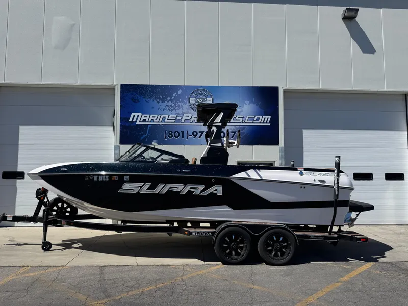 The Image of 2021 Supra SL 550 boat on trailer outside Marine Products store. - 0
