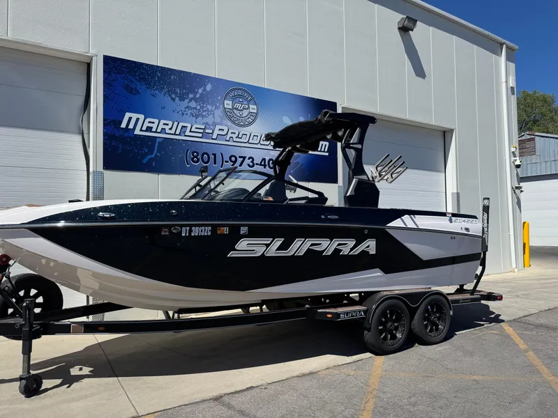 Slide: The Image of 2021 Supra SL 550 boat on trailer outside Marine Products building. - 4
