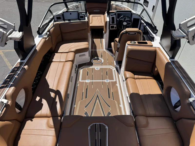 Slide: The Image of Luxurious interior of 2021 Supra SL 550 boat with brown leather seating and modern dashboard. - 8